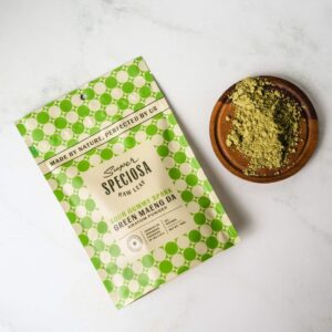 package of Super Speciosa Kratom Powder Sour Gummy Spark next to kratom powder