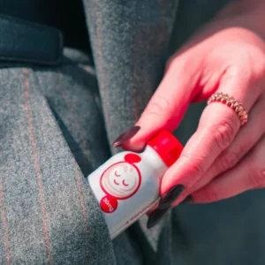 hand putting Hydroxie Kratom Pseudo Shot into pocket